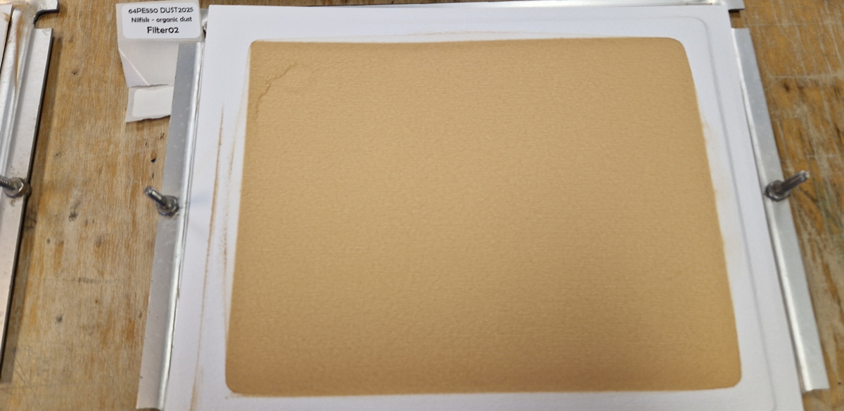 After 24 hours, the filters from the samplers are bright orange with dust