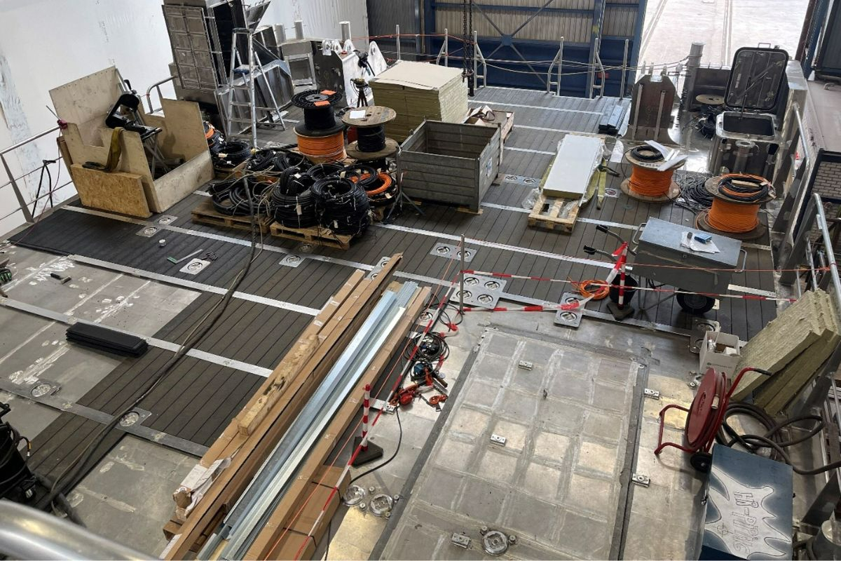   View from the bridge to the aft deck. Materials are currently being stored on the sections of the deck where the synthetic deck panels have already been installed.  