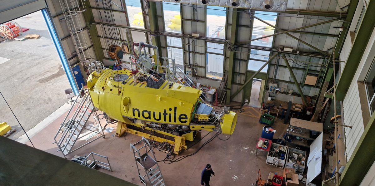 Submersible Nautile in the IFREMER workshop. See technician for scale.